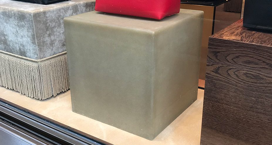 Grey moulded cube used as a display plinth in a shop window